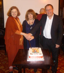 Kim, Mary and Paul cutting the cake